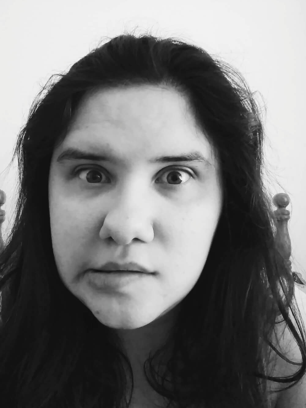 Black-and-white selfie of a wide-eyed countenance and slight look of "uh-oh" in mouth