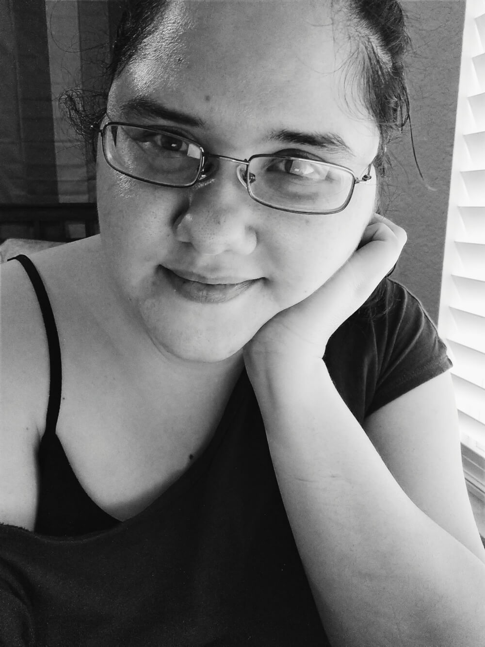 Black-and-white selfie in glasses and oversized top