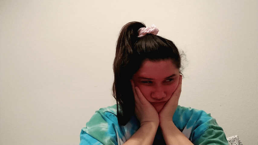 GIF me turquoise tie dye shirt pink ponytail hands face looking to side